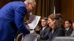 Senate Majority Leader Charles Schumer shakes Myrna Pérez's hand