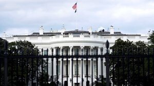 Shot of the White House past a fence