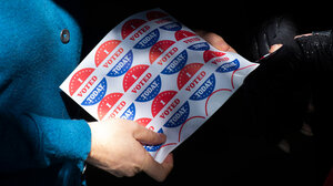 Woman holds "I Voted Today" stickers.