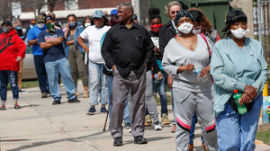 Residents wait in long line to vote in a presidential primary election outside the Riverside High School in Milwaukee, Wisconsin, on April 7, 2020