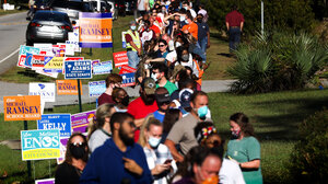 Voters wait in a very long line to vote. 