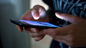 Close-up shot of hands using a cell phone