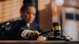 A Black woman judge bangs her gavel