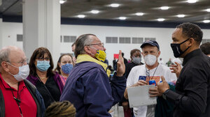 Protesters confront an election official