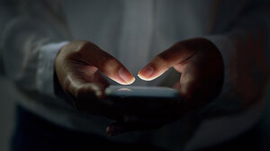 Close-up shot of hands using a cell phone