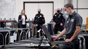 A Clark County election worker checks a voting machine 