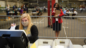 Poll watcher observing voter