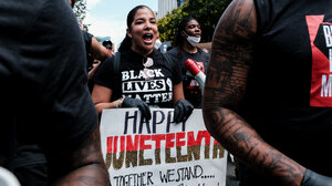 Person holding Juneteenth sign