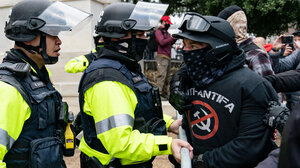 A participant in the January 6th riot confronts police
