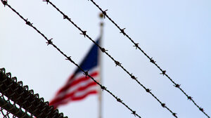 The U.S. flag behind barbed wire
