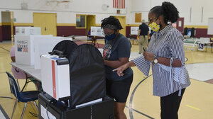 A voter being assisted to cast her ballot