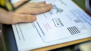 Person holding a Texas mail ballot