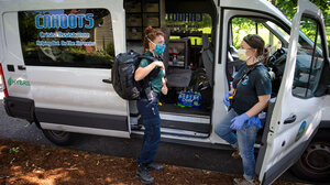 CAHOOTS first responders from Eugene, Oregon, talk outside their van.