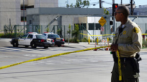 Officer putting up caution tape
