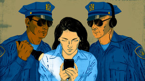 Two police officers watching a woman looking at her phone