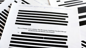 Classified documents with portions redacted