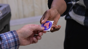 two hands holding a voting sticker