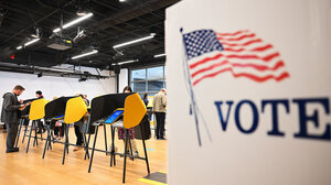 People casting ballots at polling place