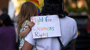 Little girl holding sign that reads "Fight for women's rights!"