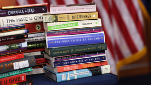Two piles of books on a table