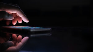 Person holding smartphone in the dark