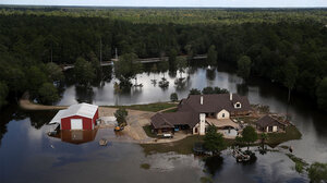 home in Texas surrounded by floodwaters