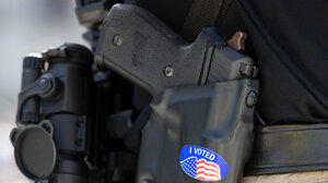 An “I VOTED” sticker on a gun holster.
