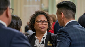 California Assemblymember Mia Bonta talking to other assemblymembers