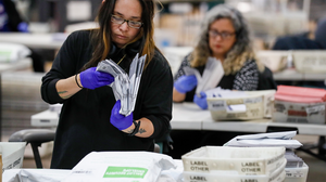 Person counting election ballots