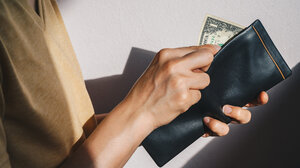 Person holding $1 bill