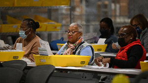 Election workers review documents. 