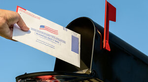 Mail ballot going into a mail box