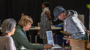 Election workers assisting a voter