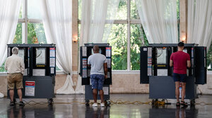 People at voting booths