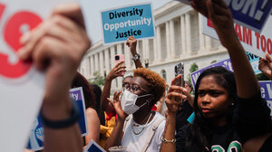 Protesters with pro-diversity and inclusion signs
