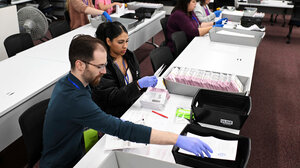 Election workers handling ballots