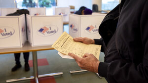 person holding paper ballot