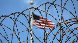 Flag behind barbed wire