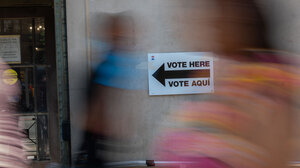 Vote Here Vote Acqí sign