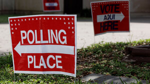 Red polling place sign with arrow