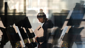 Man voting at line of voting booths