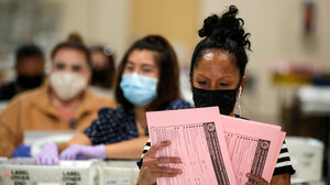 Election workers reviewing ballots