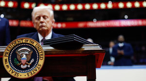 Donald Trump with presidential seal in foreground