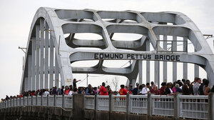 People marching on Edmund Pettus Bridge in Selma, AL