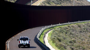 Border Patrol car driving along U.S.–Mexico border