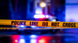 police tape foreground and siren lights