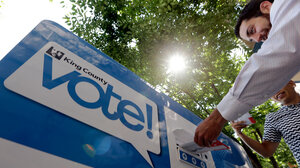 Voter delivering ballot to King County ballot drop box