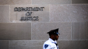 Signage and officer outside the Department of Justice