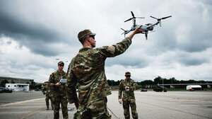 A U.S. soldier launching an armed drone
