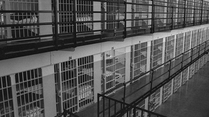 Three floors of prison cells in black and white